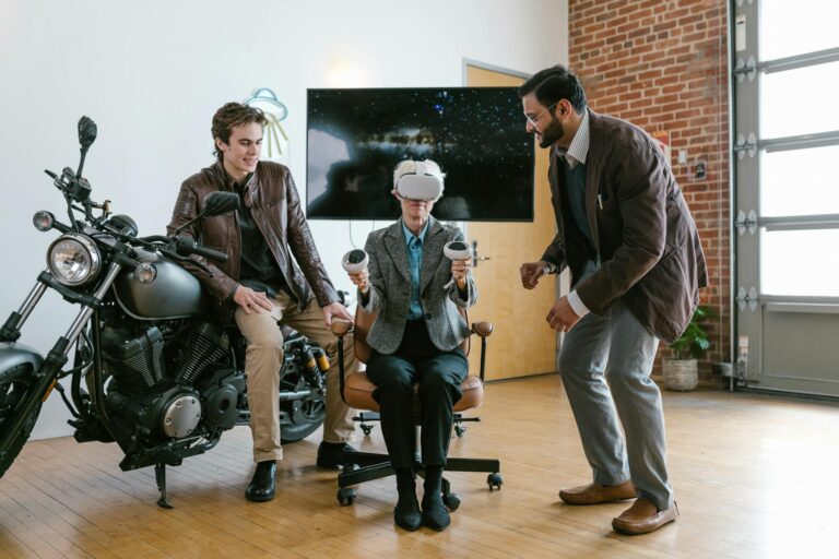 Two men assist a seated colleague with a virtual reality headset in a stylish, brick-walled office.